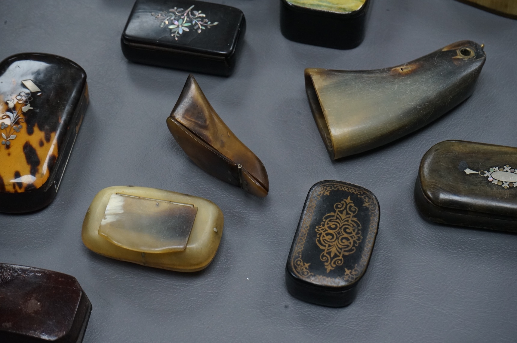 Eleven assorted horn, lacquered and ebony snuff boxes, the majority 19th century, largest 8.5cm long.